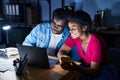 African american man and woman business workers using laptop and smartphone at office