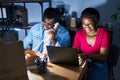 African american man and woman business workers using laptop talking on the telephone at office