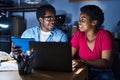 African american man and woman business workers using laptop and touchpad working at office Royalty Free Stock Photo