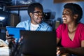 African american man and woman business workers using laptop and touchpad working at office Royalty Free Stock Photo