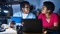 African american man and woman business workers using laptop and touchpad working at office Royalty Free Stock Photo