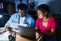 African american man and woman business workers using laptop working at office