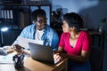 African american man and woman business workers using laptop working at office