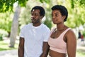 African american man and woman couple standing together with serious expression at park Royalty Free Stock Photo