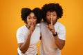 African american man and woman showing silence gesture Royalty Free Stock Photo