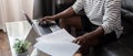 African American man working with laptop computer remote while sitting at sofa in living room. Black guy do freelance Royalty Free Stock Photo