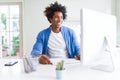 African American man working using computer with a happy face standing and smiling with a confident smile showing teeth Royalty Free Stock Photo