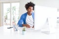 African American man working using computer with a happy face standing and smiling with a confident smile showing teeth Royalty Free Stock Photo