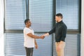 African American manager wearing casual clothes shake hand of man client or customer making business deal at office Royalty Free Stock Photo