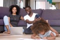 African American married couple using laptop while daughter playing Royalty Free Stock Photo
