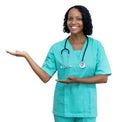 African american mature adult nurse pointing sideways