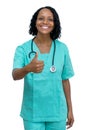 African american mature adult nurse showing thumb up