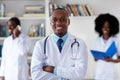 African american mature doctor with medical team Royalty Free Stock Photo