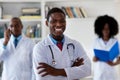 African american mature general practitioner with medical team Royalty Free Stock Photo