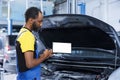 Mechanic watches video on mockup tablet