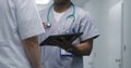 African American medic shows medical test results on digital tablet