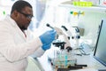 African-american medical doctor working in research lab. Science assistant making pharmaceutical experiments. Chemistry Royalty Free Stock Photo