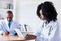 African american medical student at computer with male doctor Royalty Free Stock Photo