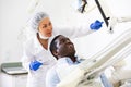 Man patient and woman dentist looking at monitor during consultation Royalty Free Stock Photo