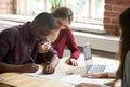 Multiethnic couple signing house purchase agreement. Royalty Free Stock Photo