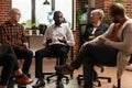 African american man talking to people and therapist at aa group meeting Royalty Free Stock Photo