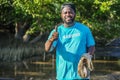 African American men volunteer thumbs up after helpers planting trees in mangrove forest for environmental protection and ecology