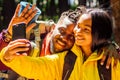 African american mixed race couple in forest making selfie Royalty Free Stock Photo