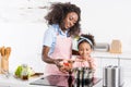 african american mom and daughter cooking on electric Royalty Free Stock Photo