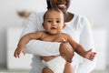 African American mom hugging her cute baby at home Royalty Free Stock Photo