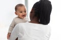 African American mom hugging her cute infant Royalty Free Stock Photo