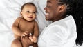 African American mom lying in bed with her cute baby Royalty Free Stock Photo