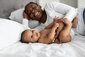 African American mom lying in bed with her sweet baby Royalty Free Stock Photo