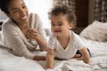 African American mom play with happy toddler in bedroom Royalty Free Stock Photo