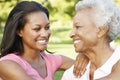 African American Mother And Adult Daughter Relaxing In Park Royalty Free Stock Photo
