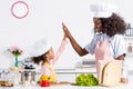 african american mother and daughter in chef hats cooking and giving high five Royalty Free Stock Photo