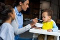 Mother and daughter feeding baby Royalty Free Stock Photo