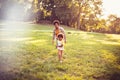 Mother and daughter running trough nature. Focus is on woman Royalty Free Stock Photo