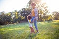 African American mother and daughter running trough park. Royalty Free Stock Photo