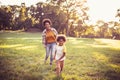 African American mother and daughter running trough park. Royalty Free Stock Photo