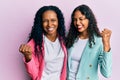 African american mother and daughter wearing business style very happy and excited doing winner gesture with arms raised, smiling Royalty Free Stock Photo