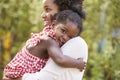 African American mother embracing with baby daughter