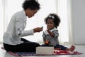 African american mother and girl child playing toy together