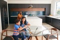 African American Mother Helping Son Studying Homework On Digital Tablet In Kitchen Royalty Free Stock Photo