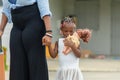 African american mother holding hand of her daughter, Sadly little girl holding and embracing her doll Royalty Free Stock Photo