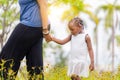 African american mother holding hand of her daughter walking in the park Royalty Free Stock Photo