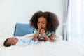 African American mother kissing foot, his 1-month-old baby newborn, with love and happy Royalty Free Stock Photo