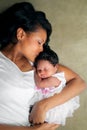 African American Mother Kissing Newborn Daughter