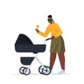 African american mother walking with newborn baby in stroller motherhood concept full length Royalty Free Stock Photo