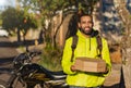 African American motoboy with pizza boxes for delivery