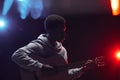 African-American Musician Playing Acoustic Guitar on Stage